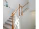 Beautiful staircase with carpet steps, wooden railing, and white banisters creating a stylish transition at 17645 Boracay Ct # 202, Venice, FL 34293