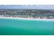 High-angle view of a beachfront community nestled between clear blue waters and a serene bay at 180 S Gulf Blvd, Placida, FL 33946