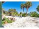 Natural sand backyard showing stairs to main house and beach vegetation at 180 S Gulf Blvd, Placida, FL 33946