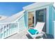 Private balcony with light blue siding features seating, a white railing, and access to the interior at 180 S Gulf Blvd, Placida, FL 33946