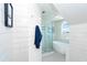 Modern bathroom with soaking tub, glass shower, and shiplap walls at 180 S Gulf Blvd, Placida, FL 33946