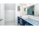 Stylish bathroom with blue tiled counter and storage shelves at 180 S Gulf Blvd, Placida, FL 33946