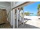 Beach access features a shower, stairs to the main house, and views of the beach and nearby palm trees at 180 S Gulf Blvd, Placida, FL 33946