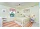 Cozy bedroom with neutral tones, a ceiling fan, and a window view to the water at 180 S Gulf Blvd, Placida, FL 33946