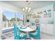 Bright dining area with round table, colorful chairs, and sliding glass doors to the deck at 180 S Gulf Blvd, Placida, FL 33946