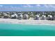 Picturesque beachfront property with a bright facade and a pristine sandy shore and aquamarine water at 180 S Gulf Blvd, Placida, FL 33946