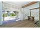 Outdoor space with wood deck, stairs, wood bench, and brick paver walkway with access to yard at 180 S Gulf Blvd, Placida, FL 33946