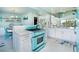 Well-equipped kitchen features retro blue oven and island with countertop space at 180 S Gulf Blvd, Placida, FL 33946