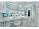 Bright, open kitchen with white cabinets, quartz countertops, and decorative blue accents at 180 S Gulf Blvd, Placida, FL 33946