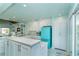 Spacious open kitchen with white cabinets, a retro refrigerator, and an island counter at 180 S Gulf Blvd, Placida, FL 33946