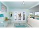 Bright living room with white sofa, coastal accents, and sliding doors at 180 S Gulf Blvd, Placida, FL 33946