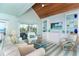 Bright living room boasts a full wall of cabinetry, comfortable seating, and nice natural light at 180 S Gulf Blvd, Placida, FL 33946