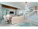 Open-concept living room with comfortable seating, stairs, and a staircase at 180 S Gulf Blvd, Placida, FL 33946