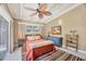 Comfortable bedroom with a ceiling fan, a backyard view, and a vibrant striped rug at 20 Spaniards Rd, Placida, FL 33946