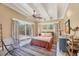 Comfortable bedroom with a ceiling fan, sliding glass doors to the backyard, and a vibrant striped rug at 20 Spaniards Rd, Placida, FL 33946