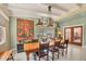 Open dining room featuring a large table, tapestry and large windows at 20 Spaniards Rd, Placida, FL 33946