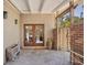 Inviting entryway with brick flooring and French doors leading to the side patio and lush tropical landscaping at 20 Spaniards Rd, Placida, FL 33946