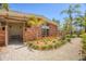 Single-story brick home featuring an enclosed side patio, manicured front yard, and crushed gravel walkway at 20 Spaniards Rd, Placida, FL 33946