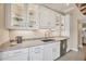 Bright kitchen features white cabinets, granite countertops, stainless steel appliances and under cabinet lighting at 20 Spaniards Rd, Placida, FL 33946