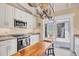 Bright galley kitchen features white cabinets, stainless steel appliances, and access to the patio at 20 Spaniards Rd, Placida, FL 33946