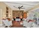 Bright living room features a ceiling fan, a tapestry, and comfortable white wicker seating at 20 Spaniards Rd, Placida, FL 33946