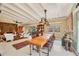 Bright, open-concept living room featuring a dining area, with high ceilings and a view to the pool at 20 Spaniards Rd, Placida, FL 33946