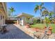 Back patio with brick pavers, outdoor seating, and views of the tropical backyard at 20 Spaniards Rd, Placida, FL 33946