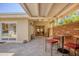 Inviting patio with brick flooring, comfortable seating, and views of the dining room through the French doors at 20 Spaniards Rd, Placida, FL 33946