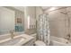 Neutral bathroom with shower/tub combo, patterned curtain, and under-sink vanity at 2117 Laurifolia Ct, North Port, FL 34289