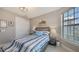 Cozy bedroom with a striped bedspread, a window, and a closet at 2117 Laurifolia Ct, North Port, FL 34289