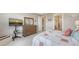 This inviting bedroom showcases a dresser with mirror and a view of an ensuite bathroom for added convenience at 2117 Laurifolia Ct, North Port, FL 34289