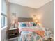 Inviting bedroom featuring coastal-themed decor, a comfortable bed, and bedside tables at 2117 Laurifolia Ct, North Port, FL 34289