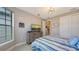 Charming bedroom with a striped bedspread, dresser, and window with blinds at 2117 Laurifolia Ct, North Port, FL 34289