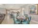 An open dining area with a round table, seating for four, and view into the kitchen at 2117 Laurifolia Ct, North Port, FL 34289
