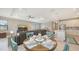 Dining area with table and chairs with a view to the living room and modern kitchen at 2117 Laurifolia Ct, North Port, FL 34289