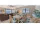Open dining area with decorative table set and a view into the spacious living room at 2117 Laurifolia Ct, North Port, FL 34289