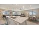 Open-concept kitchen with island and views into the living room and dining area, ideal for entertaining at 2117 Laurifolia Ct, North Port, FL 34289