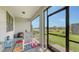 Screened lanai with brick floor features a dining table and pleasant views of the water and green backyard at 2117 Laurifolia Ct, North Port, FL 34289