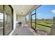 Screened-in lanai features a brick floor with a dining table and pleasant views of the water and backyard at 2117 Laurifolia Ct, North Port, FL 34289