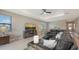 Comfortable living room with tile floors, tray ceiling, and large windows allowing ample natural light at 2117 Laurifolia Ct, North Port, FL 34289