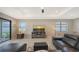 Bright and inviting living room featuring a comfortable leather sofa and neutral decor at 2117 Laurifolia Ct, North Port, FL 34289