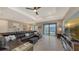 Cozy living room featuring a comfortable sectional sofa and access to the outdoor patio at 2117 Laurifolia Ct, North Port, FL 34289