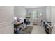 Bright office space with neutral walls, a window with blinds, and a simple desk setup at 2117 Laurifolia Ct, North Port, FL 34289