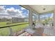 Relaxing screened-in patio with outdoor seating and views of the landscaped backyard at 2117 Laurifolia Ct, North Port, FL 34289