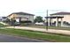 Outdoor community area featuring shade structures, seating, and manicured lawn for leisure activities at 25100 Sandhill Blvd # T101, Punta Gorda, FL 33983