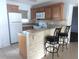 Kitchen features granite countertops, breakfast bar, and stainless appliances at 25100 Sandhill Blvd # T101, Punta Gorda, FL 33983