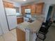 Open kitchen featuring granite countertops and stainless steel appliances at 25100 Sandhill Blvd # T101, Punta Gorda, FL 33983