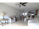 Bright and airy living room featuring tile floors and a view of the kitchen area at 25100 Sandhill Blvd # T101, Punta Gorda, FL 33983