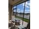 Enclosed patio featuring stylish tile flooring and a cozy seating area overlooking the water at 25100 Sandhill Blvd # T101, Punta Gorda, FL 33983