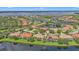 Aerial view of a community with waterfront homes, beautiful landscaping and lake views at 2669 Wax Myrtle Ct, Port Charlotte, FL 33953